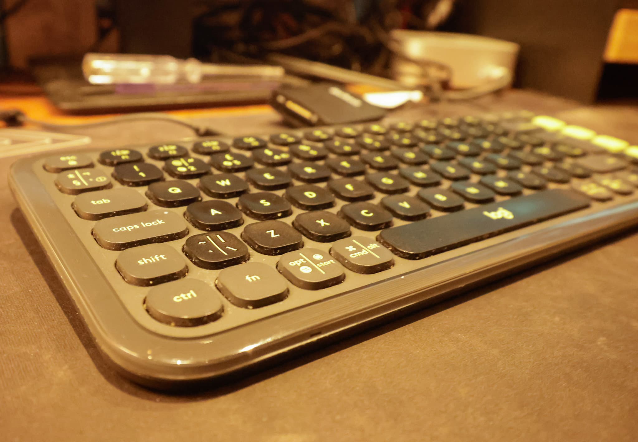 Close-up of a simple keyboard and desk setup for content creation