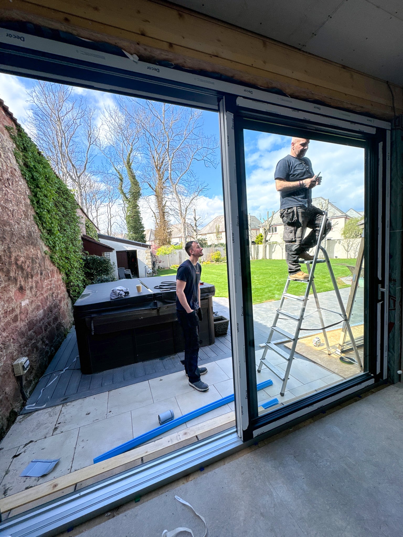 C&G Developments team installing glazed doors on a home extension
