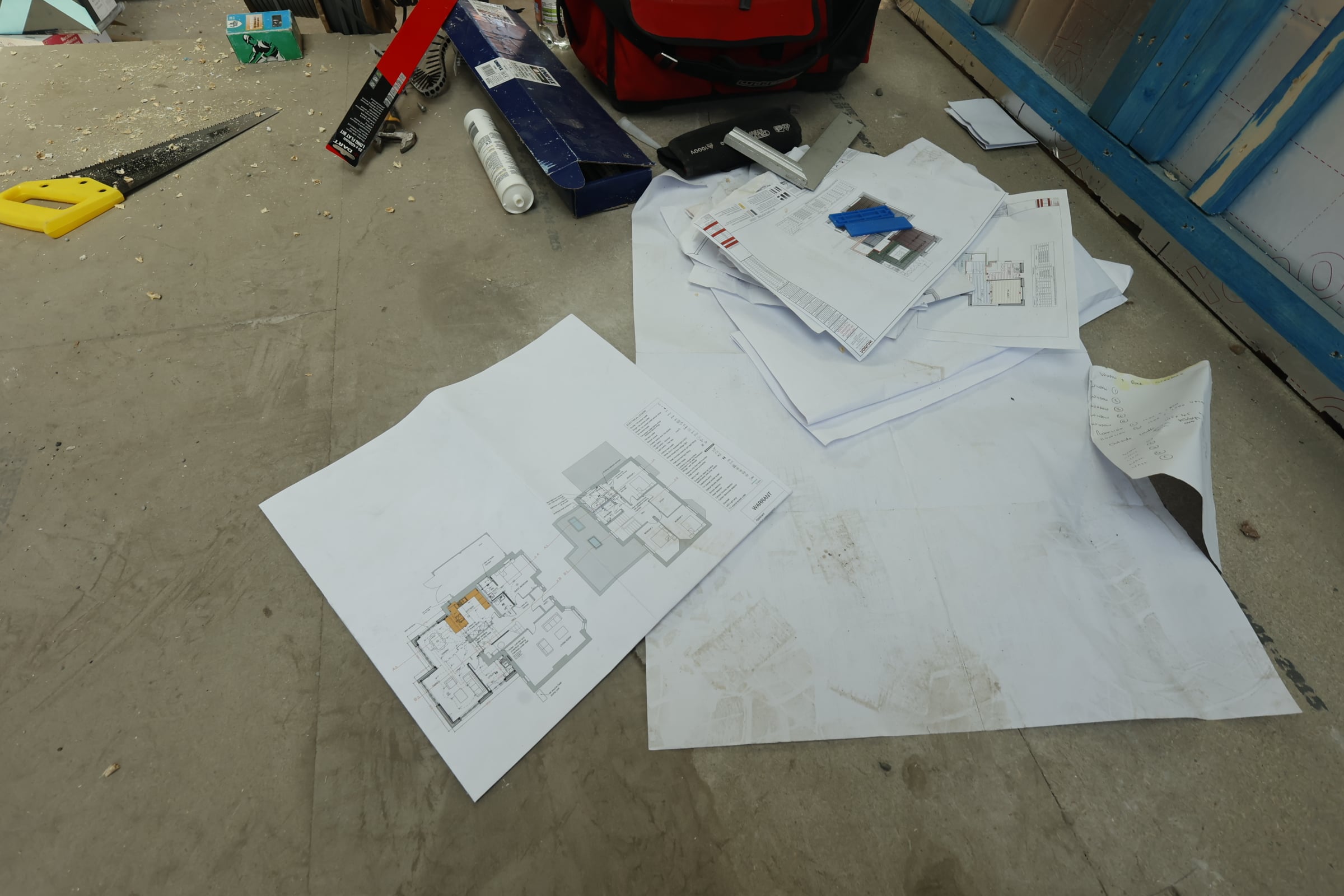Detailed project plans photographed on a C&G Developments site