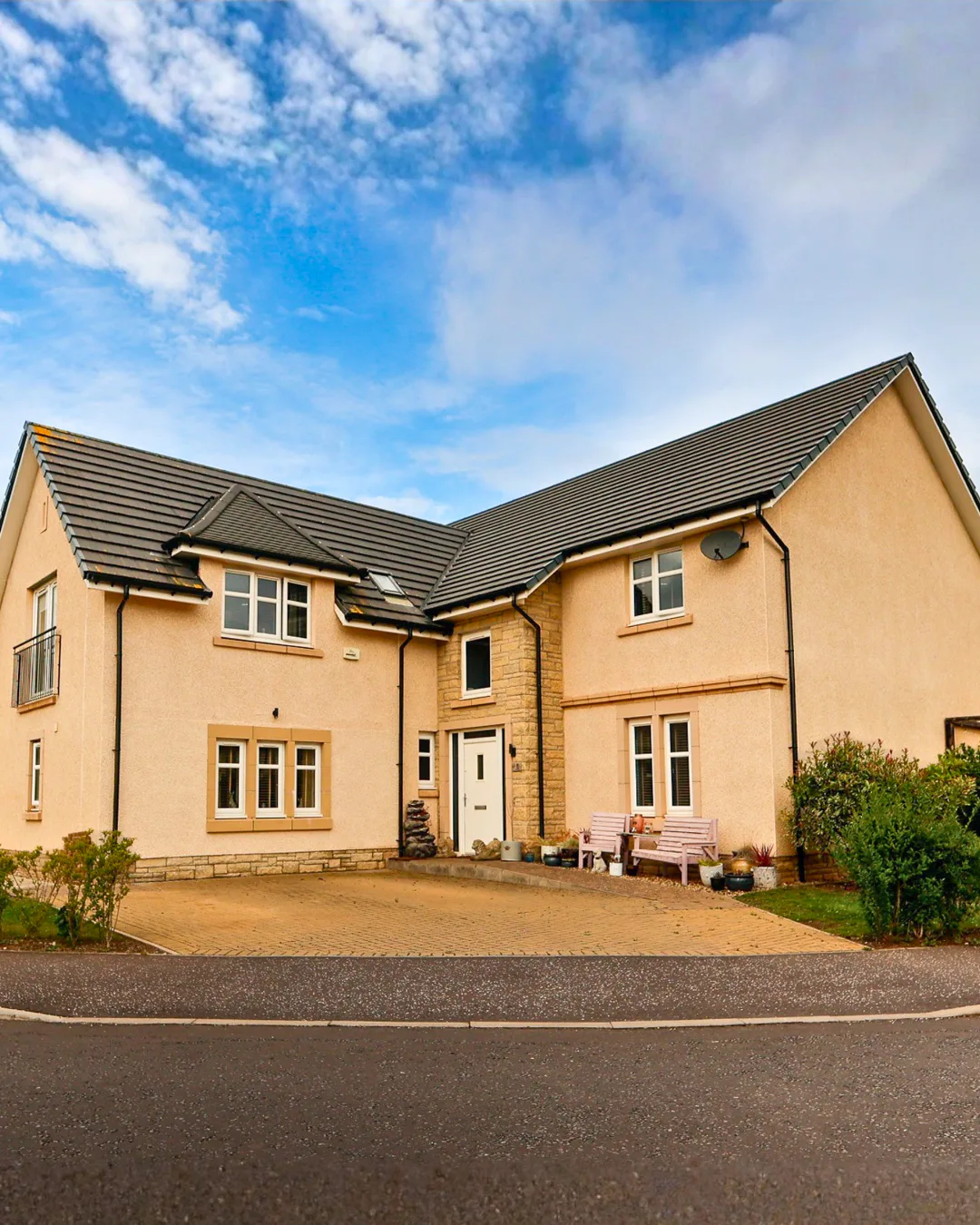 Detached Haddington home with a pale rendered exterior, pitched roofs and landscaped frontage
