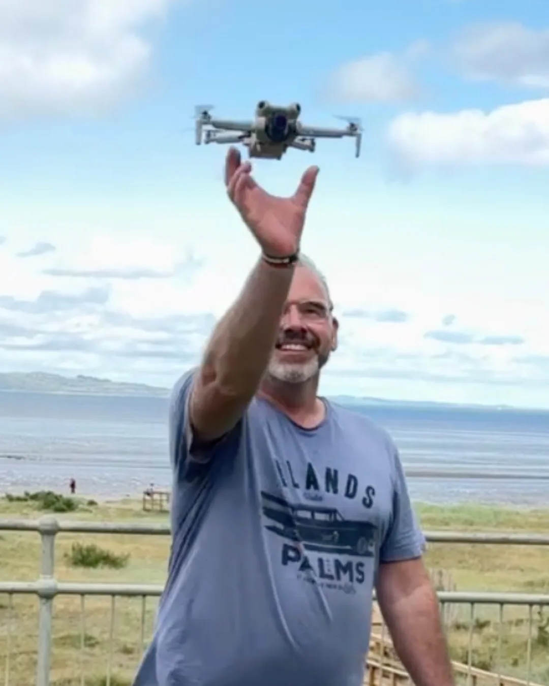Bear Media drone operator launching a drone by the coast